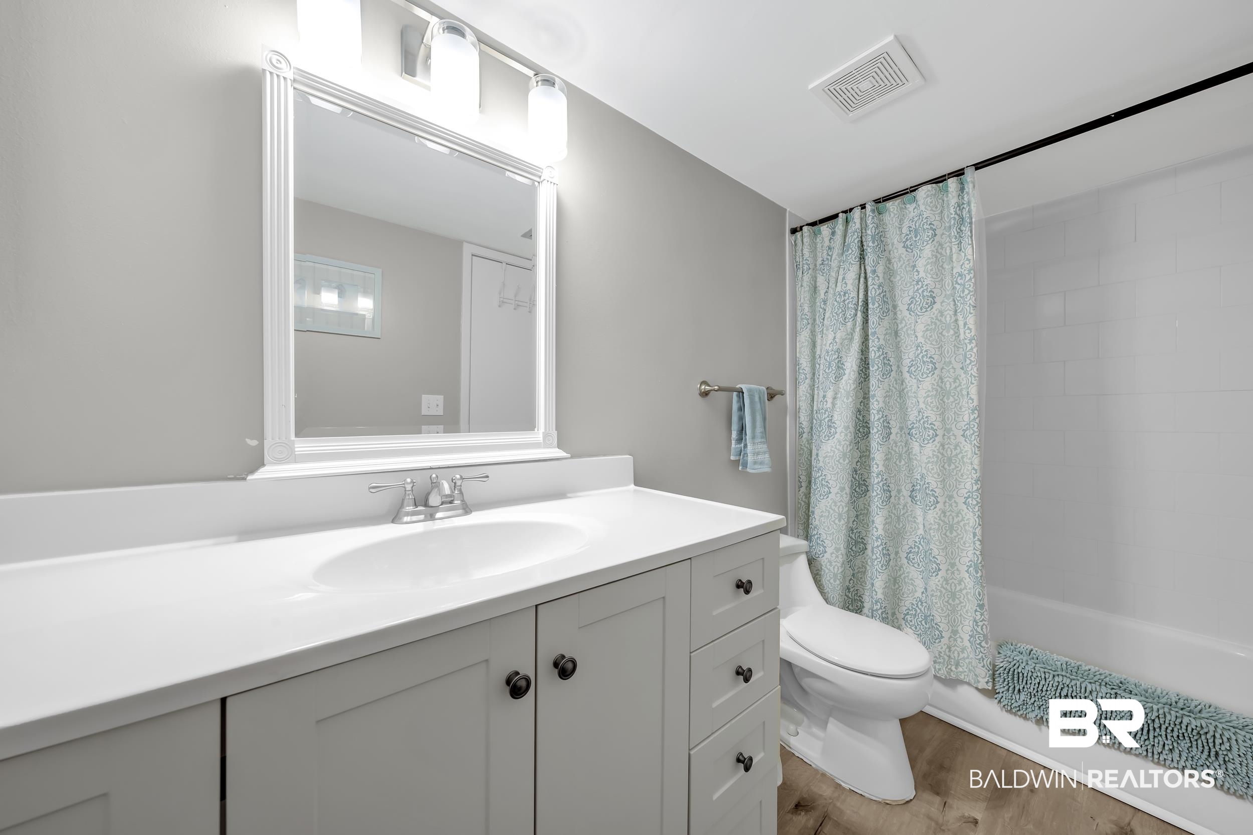 14100 River Road, Unit 211 Pensacola, FL 32507 - Photo 32 of 56 Vanity featuring an integrated white sink and polished chrome faucet