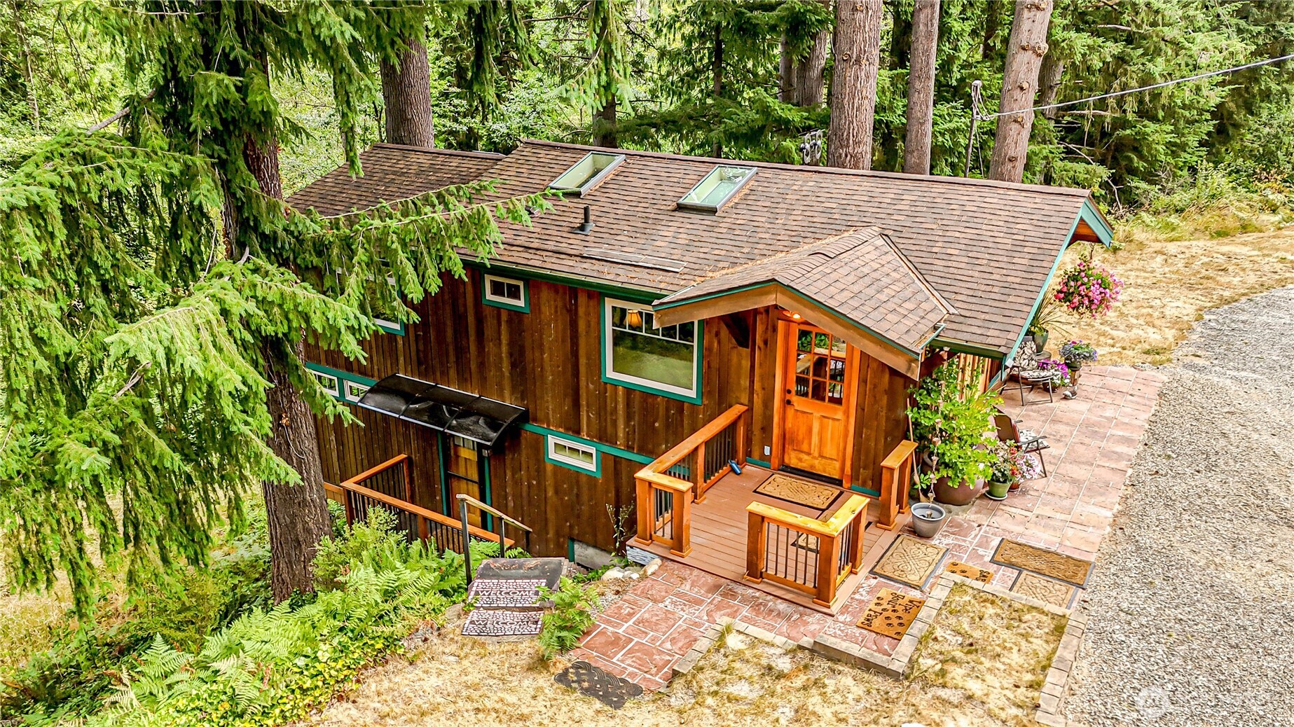 an aerial view of a house with large trees
