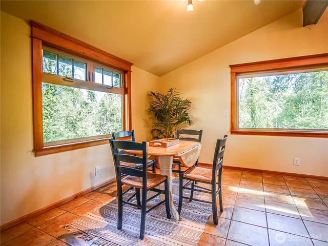 a view of a dining room with furniture and a window