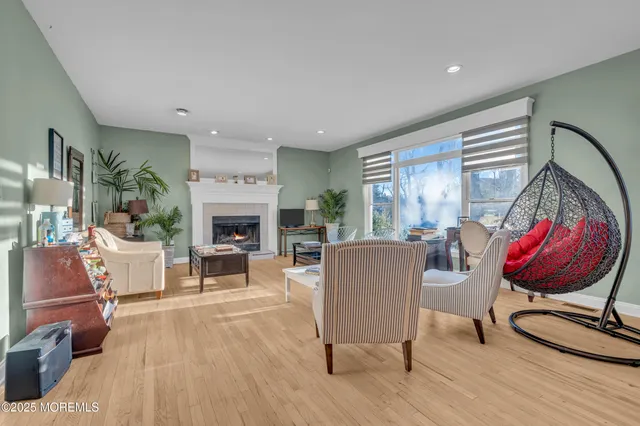 a living room with furniture fireplace and window