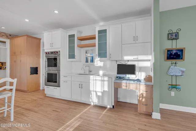 a kitchen with stainless steel appliances a stove a refrigerator and cabinets
