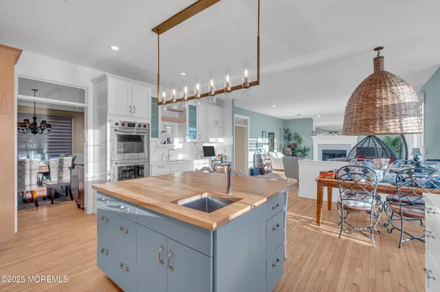 a kitchen with sink stove and refrigerator
