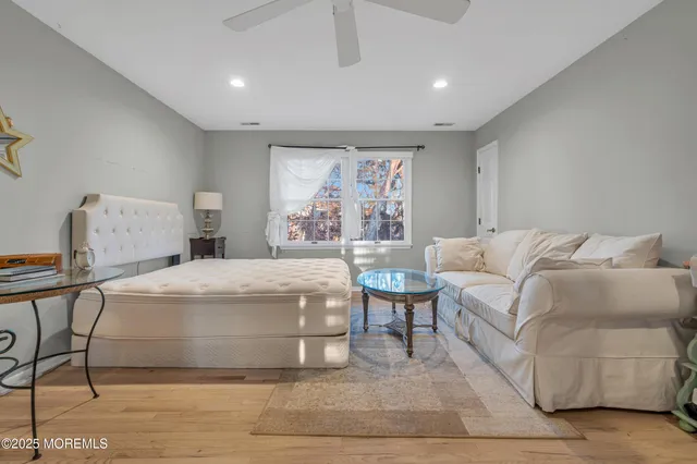 a bathroom with a tub a sink and a window