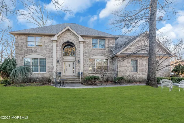 a front view of a house with a garden and plants