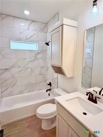 a bathroom with a sink a toilet and bathtub