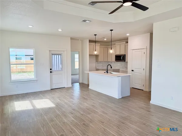 a view of a kitchen with a sink stainless steel appliances and cabinets
