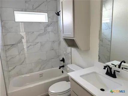 a bathroom with a sink a toilet and bathtub