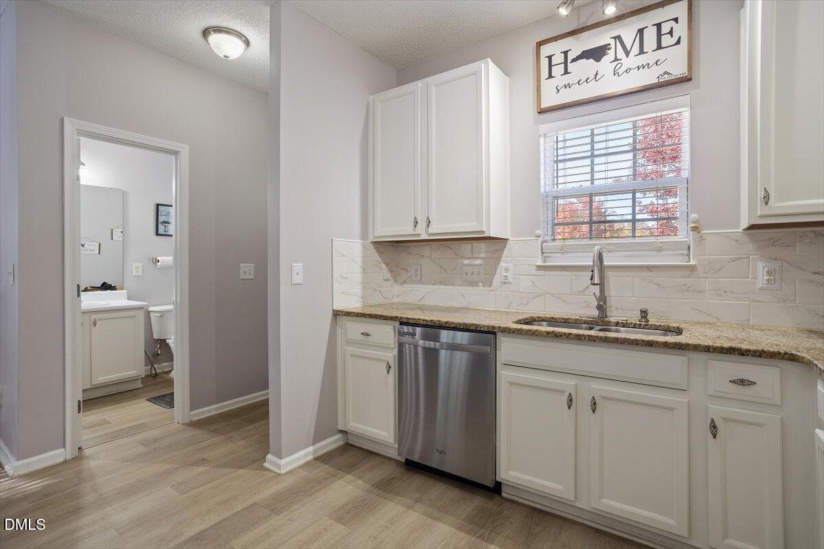 3502 Oneonta Avenue Raleigh, NC 27604 - Photo 12 of 28 a kitchen with granite countertop white cabinets and a window