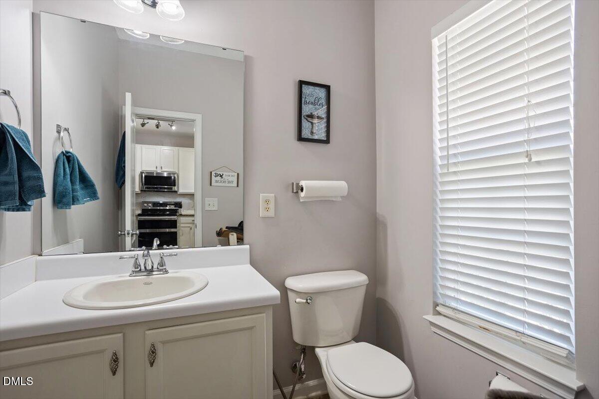 3502 Oneonta Avenue Raleigh, NC 27604 - Photo 13 of 28 a bathroom with a toilet a sink and mirror
