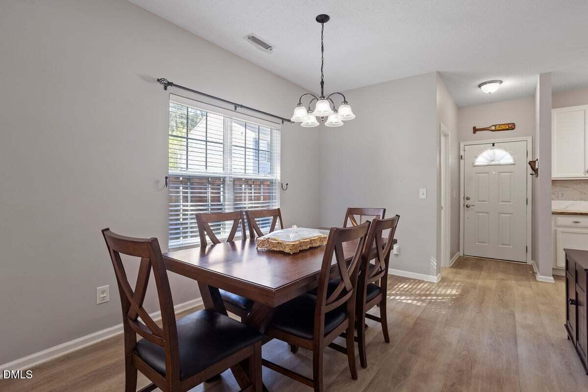 3502 Oneonta Avenue Raleigh, NC 27604 - Photo 15 of 28 a view of a dining room with furniture window and wooden floor
