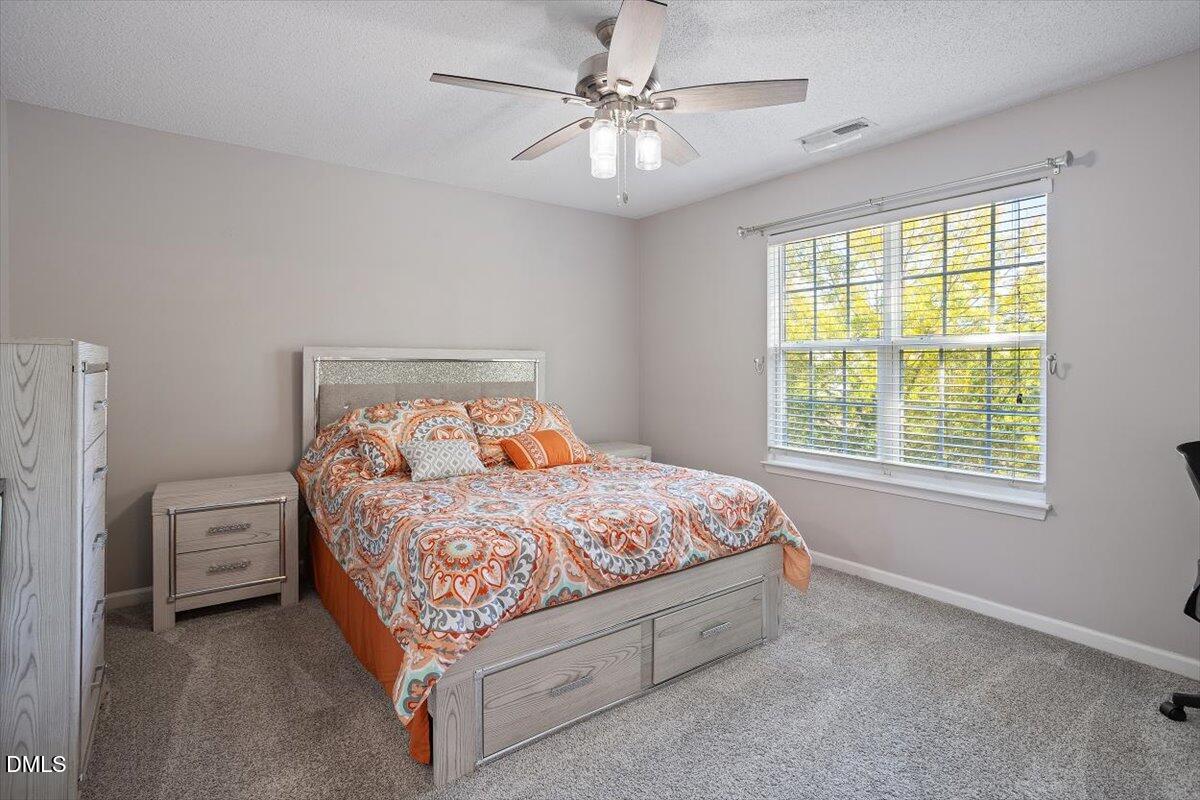 3502 Oneonta Avenue Raleigh, NC 27604 - Photo 19 of 28 a bed sitting in a bedroom next to a window