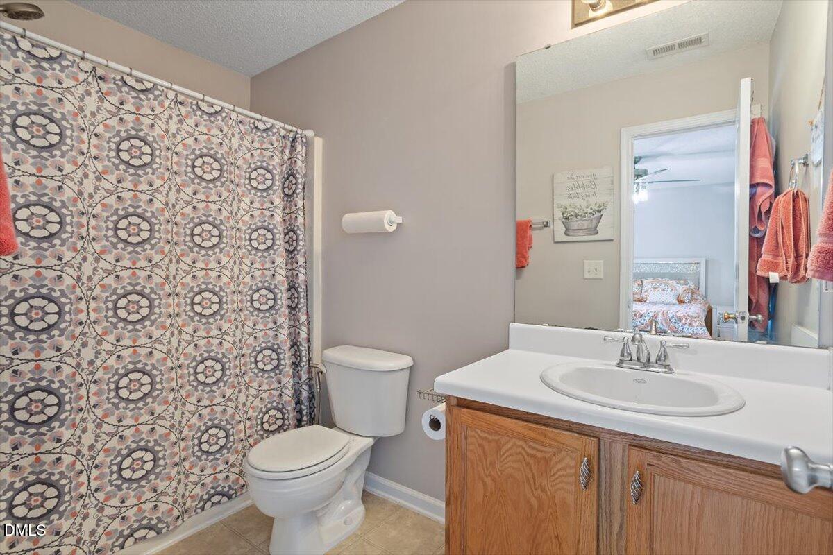 3502 Oneonta Avenue Raleigh, NC 27604 - Photo 22 of 28 a bathroom with a sink toilet and a mirror