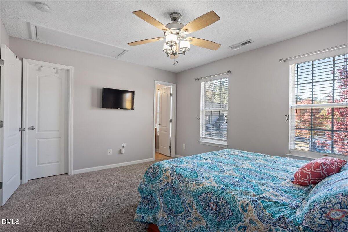 3502 Oneonta Avenue Raleigh, NC 27604 - Photo 24 of 28 a bedroom with a large bed and a chandelier