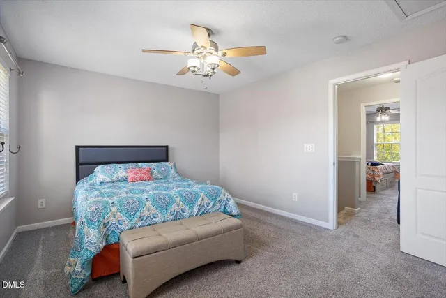 a bedroom with bed and a chandelier
