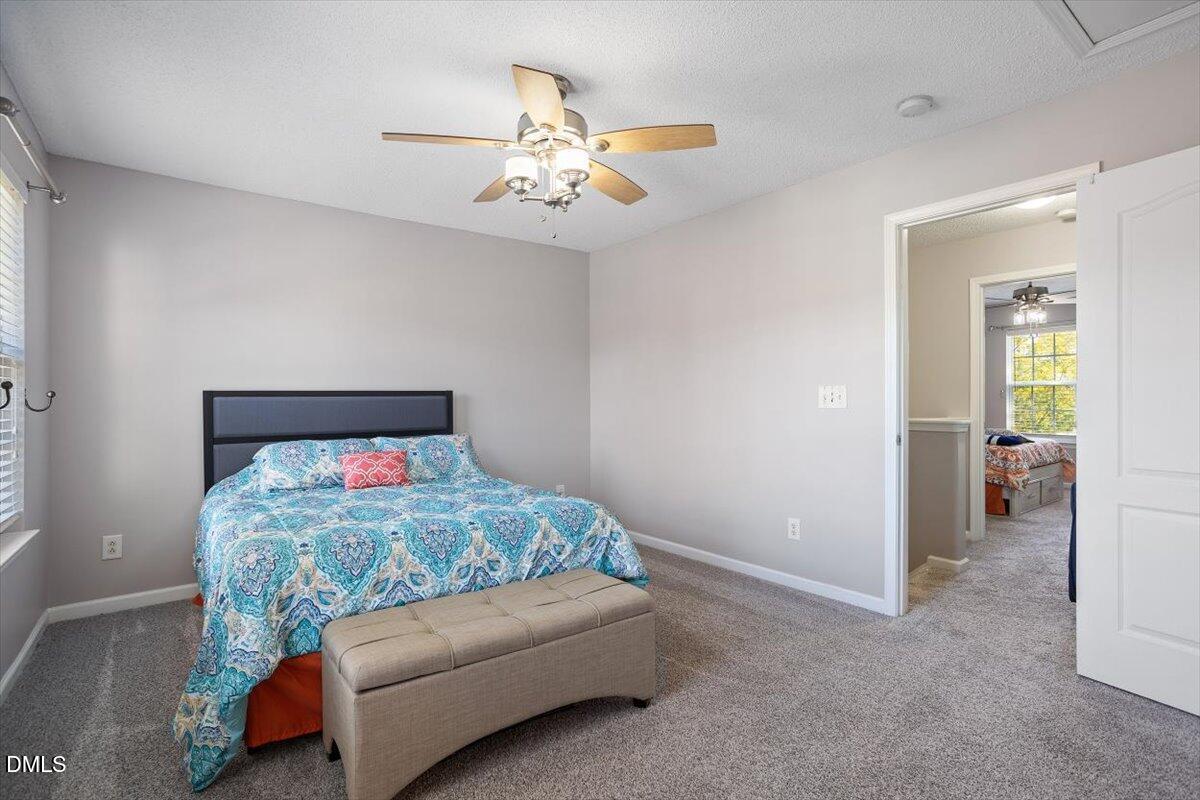 3502 Oneonta Avenue Raleigh, NC 27604 - Photo 25 of 28 a bedroom with bed and a chandelier