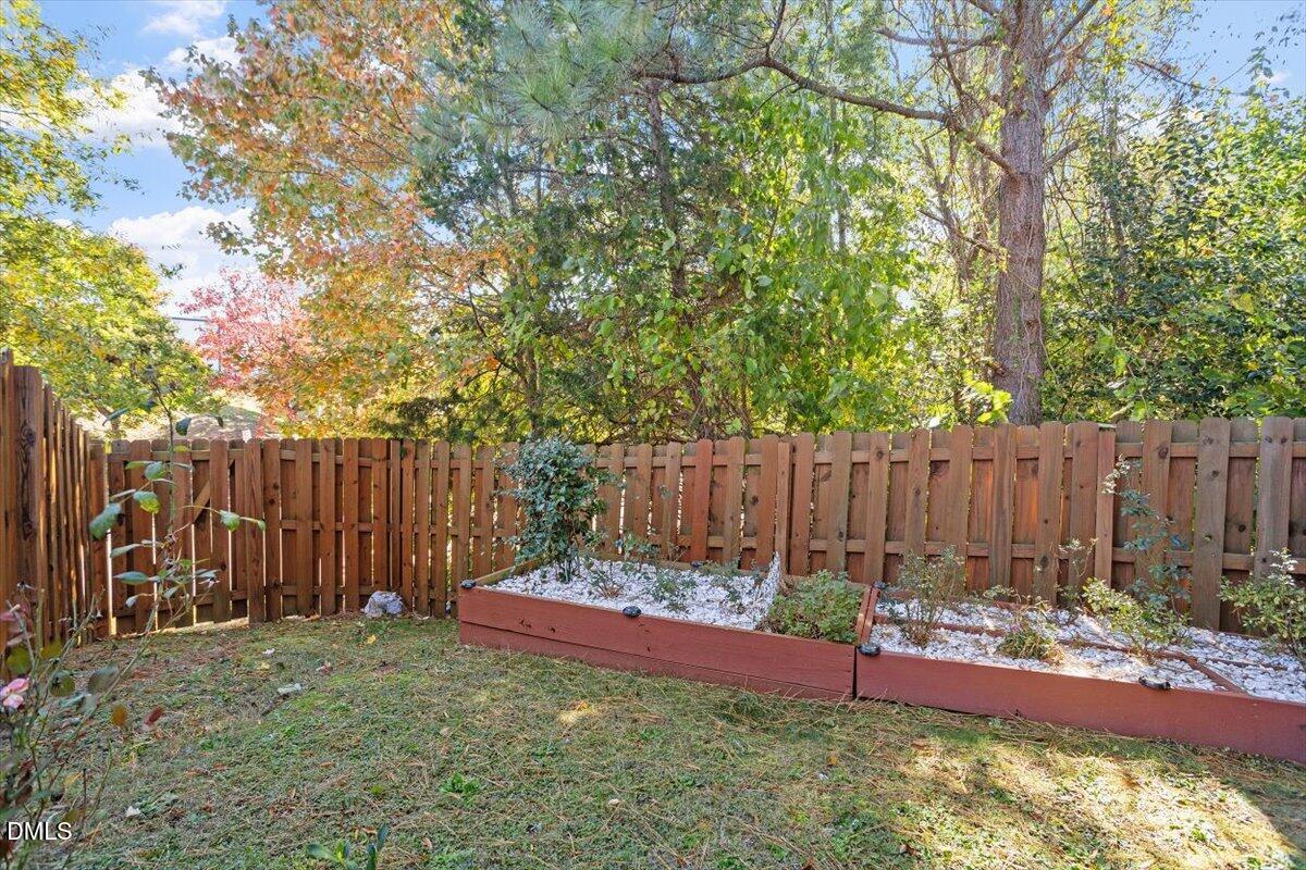 3502 Oneonta Avenue Raleigh, NC 27604 - Photo 6 of 28 a view of a backyard with a large tree and wooden fence