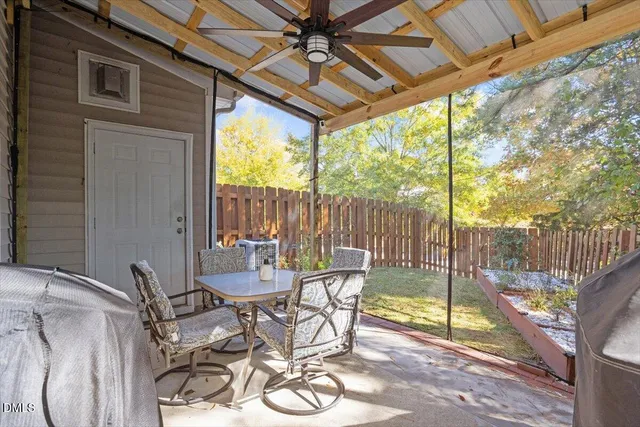 a view of a patio with a table chairs and glass door