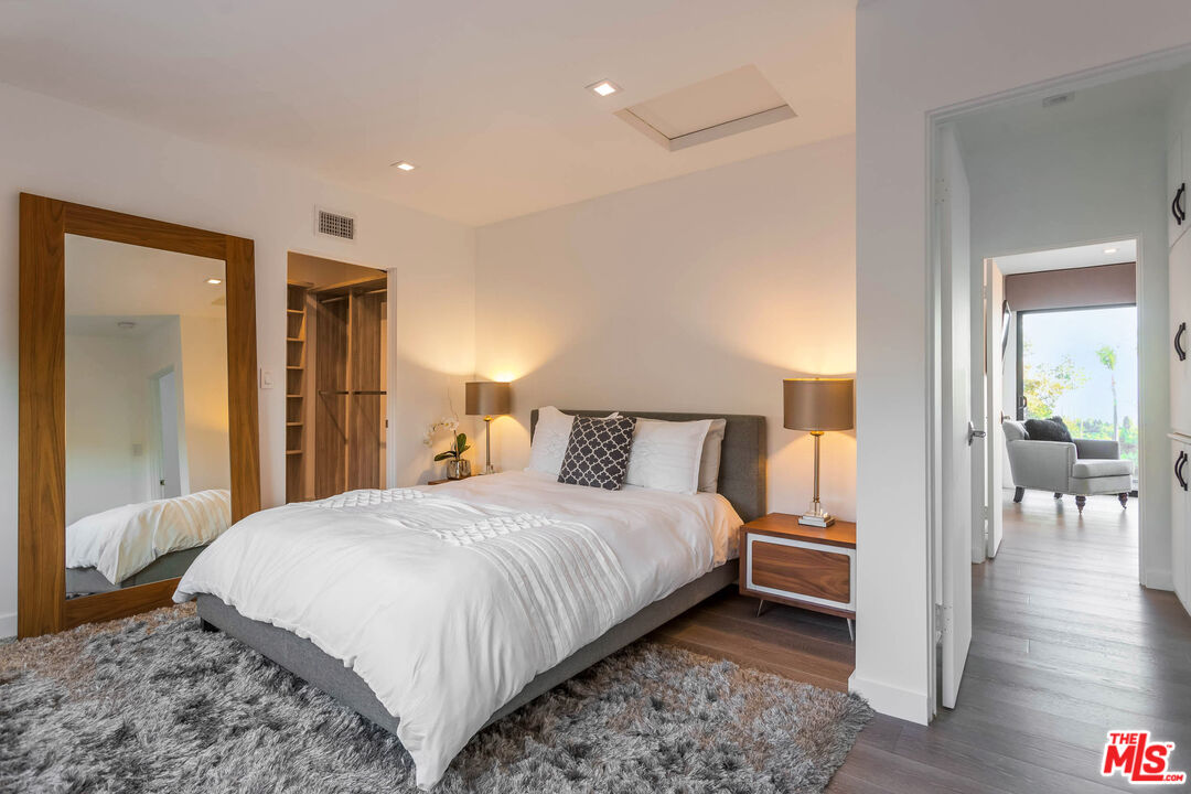 9331 Doheny Road Beverly Hills, CA 90210 - Photo 11 of 14 a bedroom with a bed and a view of bathroom