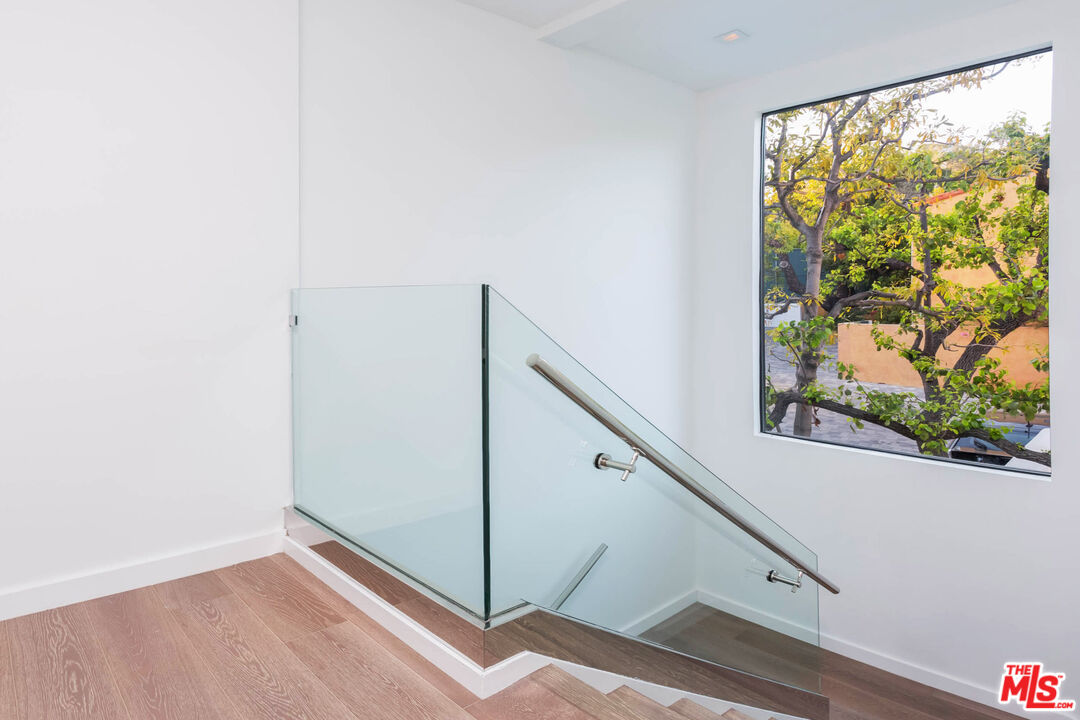 9331 Doheny Road Beverly Hills, CA 90210 - Photo 13 of 14 a view of a hallway with window