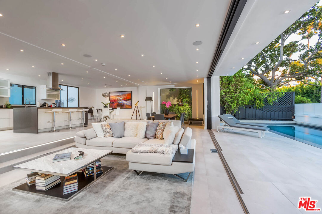 9331 Doheny Road Beverly Hills, CA 90210 - Photo 3 of 14 a living room with furniture and a large window
