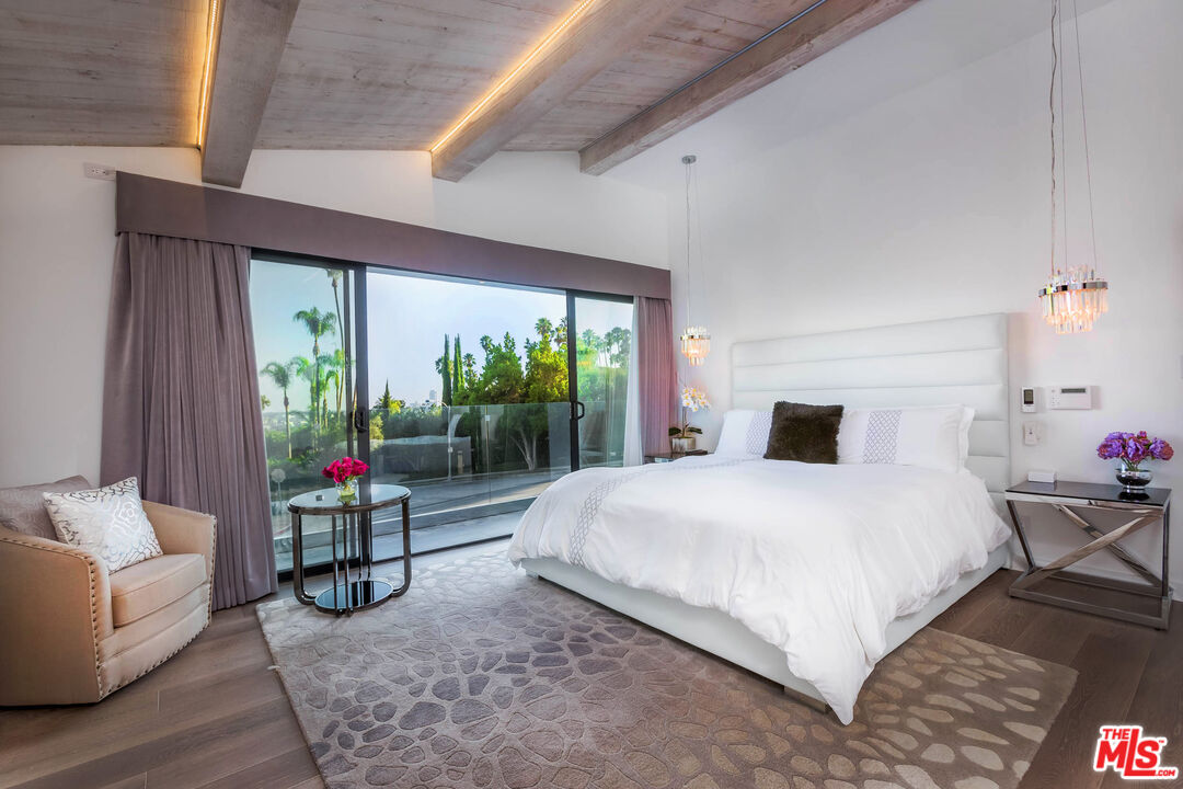 9331 Doheny Road Beverly Hills, CA 90210 - Photo 5 of 14 a bedroom with a bed and large window