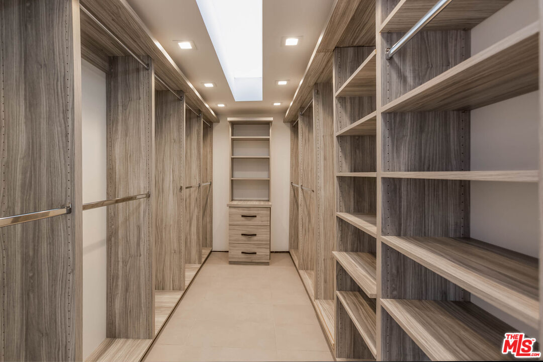 9331 Doheny Road Beverly Hills, CA 90210 - Photo 7 of 14 a view of closet area with empty racks
