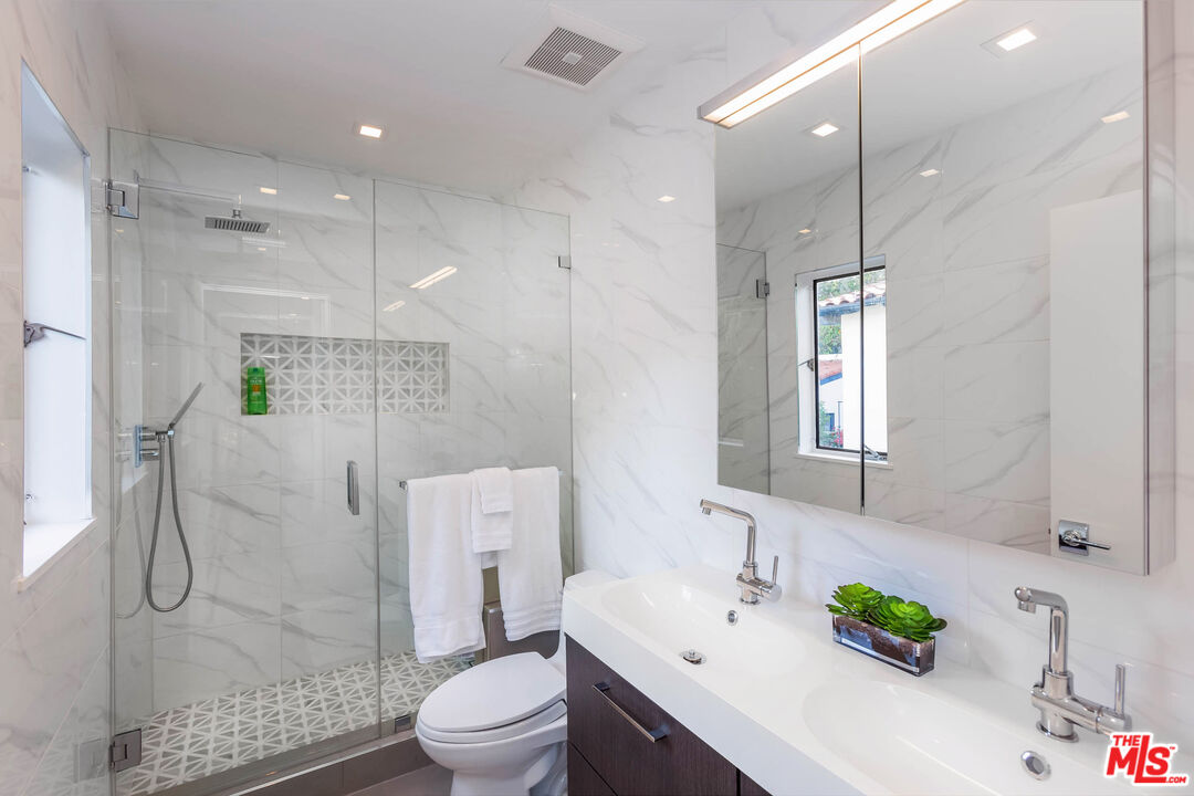 9331 Doheny Road Beverly Hills, CA 90210 - Photo 10 of 14 a bathroom with a sink a toilet and shower
