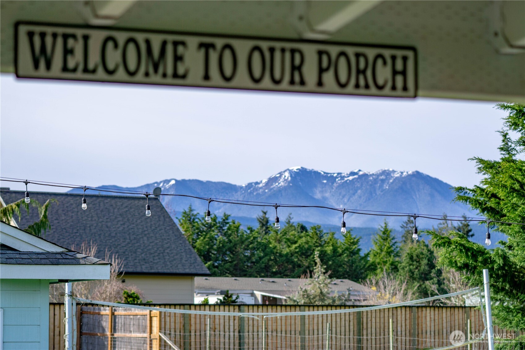 787 North Kendall Road Sequim, WA 98382 - Photo 14 of 40 a street sign that is on a wooden fence