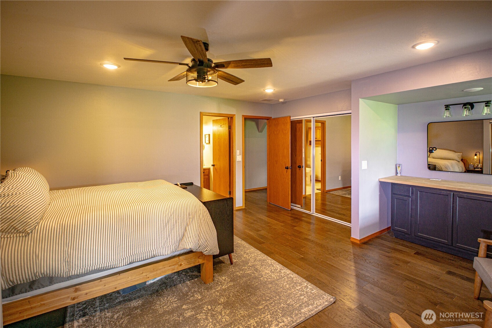 787 North Kendall Road Sequim, WA 98382 - Photo 18 of 40 a bedroom with a bed and a flat screen tv