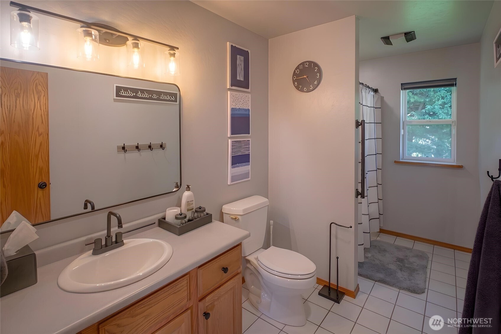 787 North Kendall Road Sequim, WA 98382 - Photo 23 of 40 a bathroom with a granite countertop sink toilet a mirror a vanity and a shower