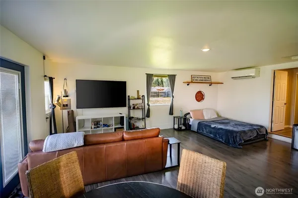 a living room with furniture and a wooden floor