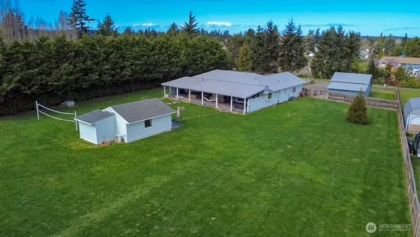 an aerial view of a house with backyard garden and trees