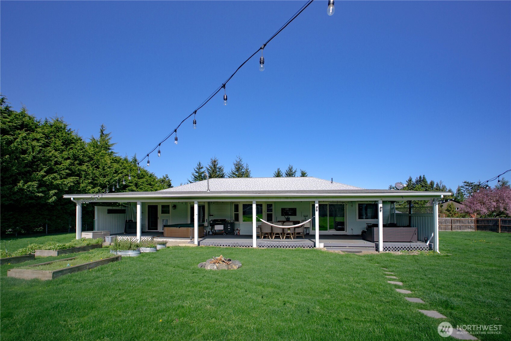 787 North Kendall Road Sequim, WA 98382 - Photo 33 of 40 a front view of a house with a yard table and chairs