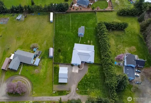 an aerial view of a house with garden space and a lake view
