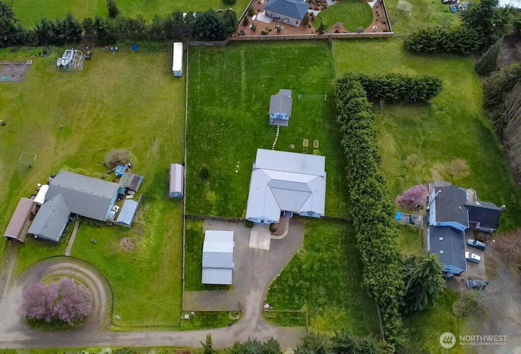 787 North Kendall Road Sequim, WA 98382 - Photo 4 of 40 an aerial view of a house with garden space and a lake view