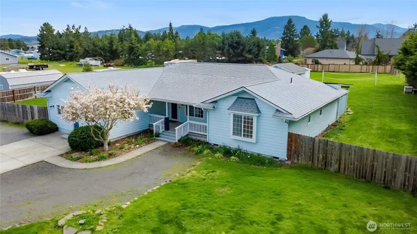a aerial view of a house with a yard table and chairs