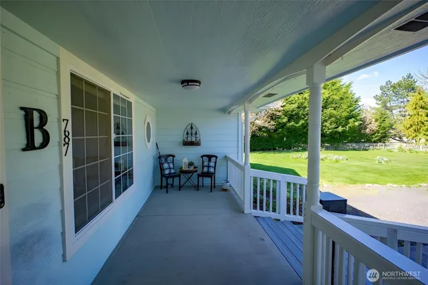 a view of a porch with chairs and backyard