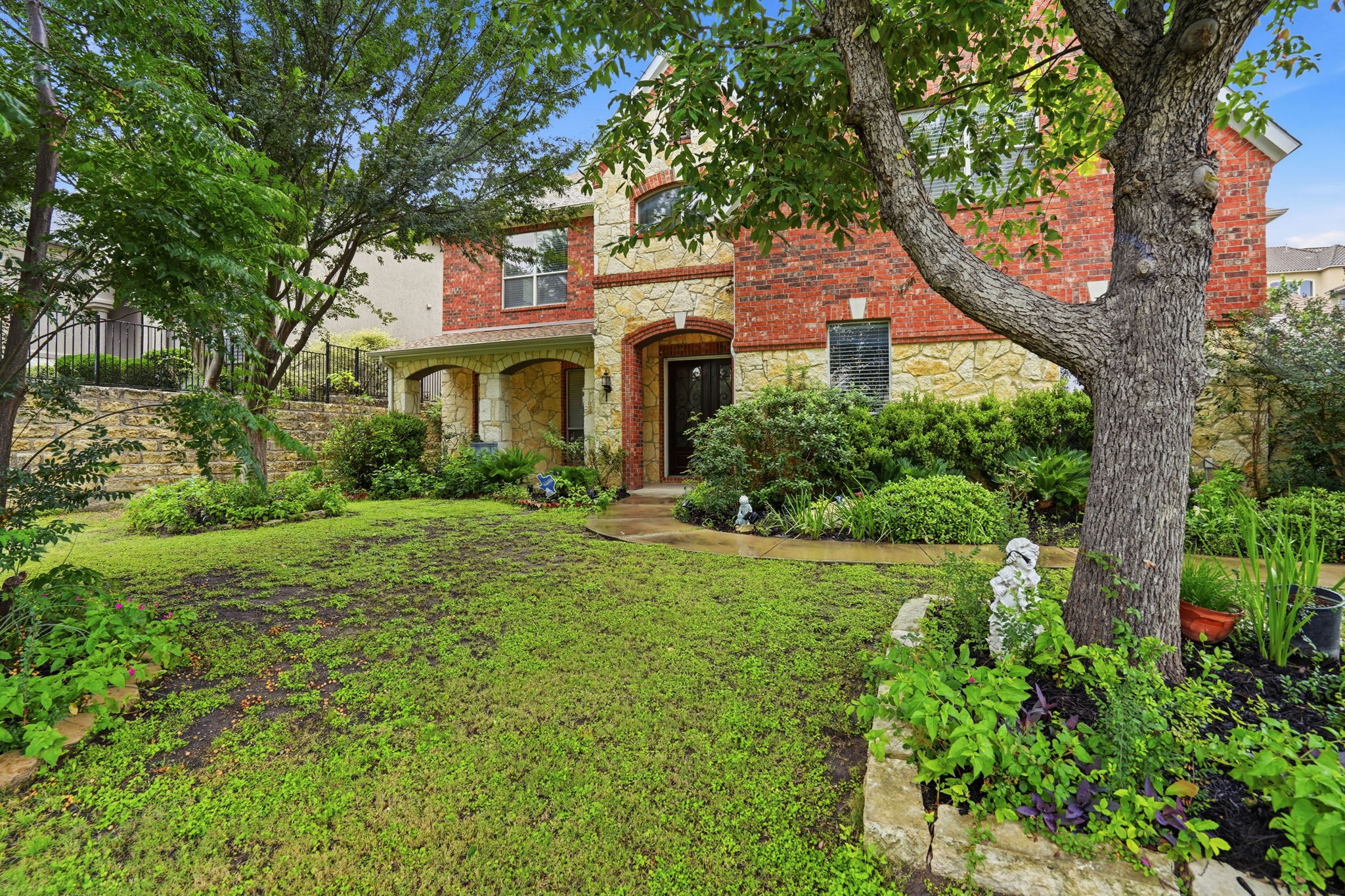 222 Vailco Lane Austin, TX 78738 - Photo 3 of 39 Stone and brick facade with arched entryways