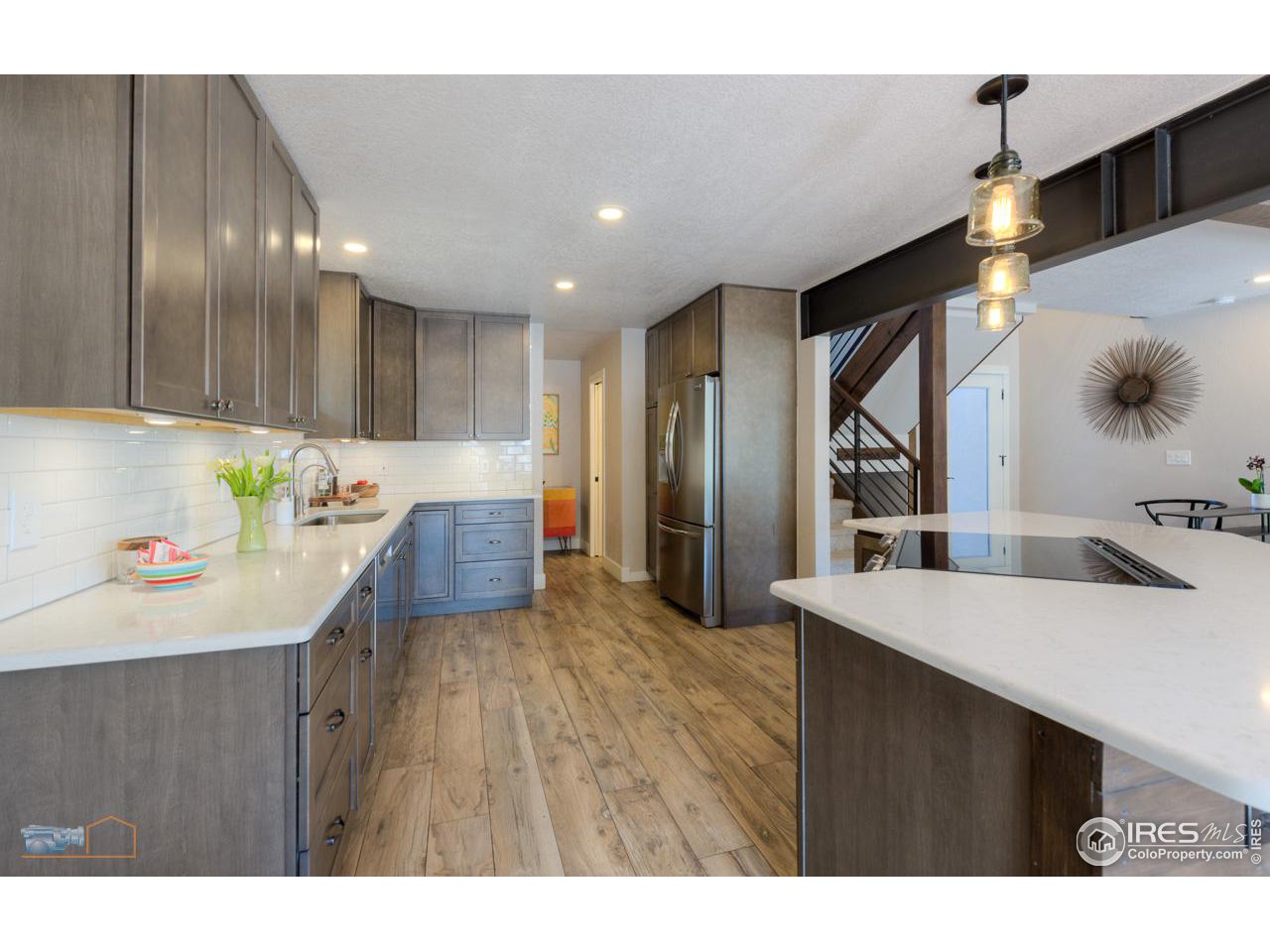 8323 West Fork Road Boulder, CO 80302 - Photo 11 of 36 a kitchen view with stainless steel appliances kitchen island a cabinets and wooden floor
