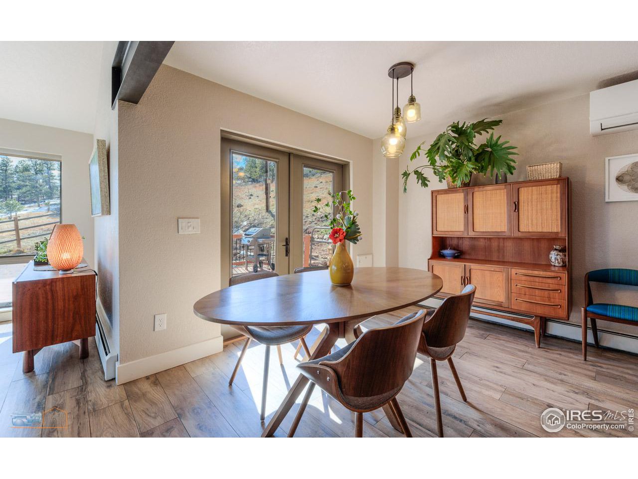 8323 West Fork Road Boulder, CO 80302 - Photo 13 of 36 a view of a dining room with furniture window and wooden floor
