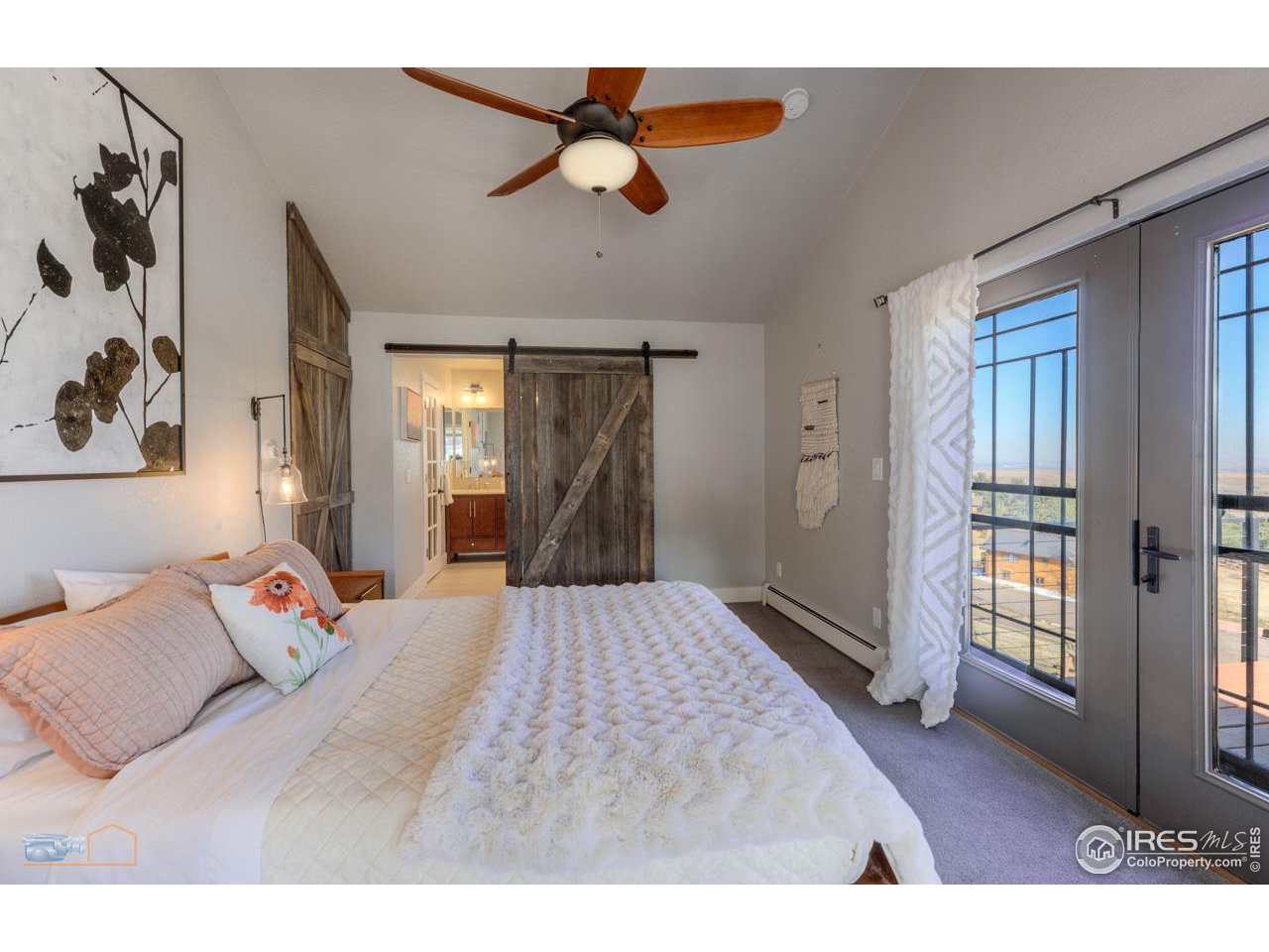 8323 West Fork Road Boulder, CO 80302 - Photo 19 of 36 a bedroom with a bed and a chandelier