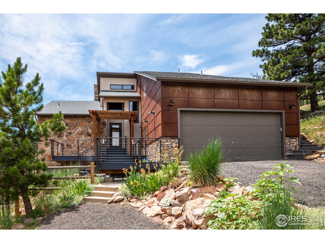 8323 West Fork Road Boulder, CO 80302 - Photo 2 of 36 a front view of a house with garden