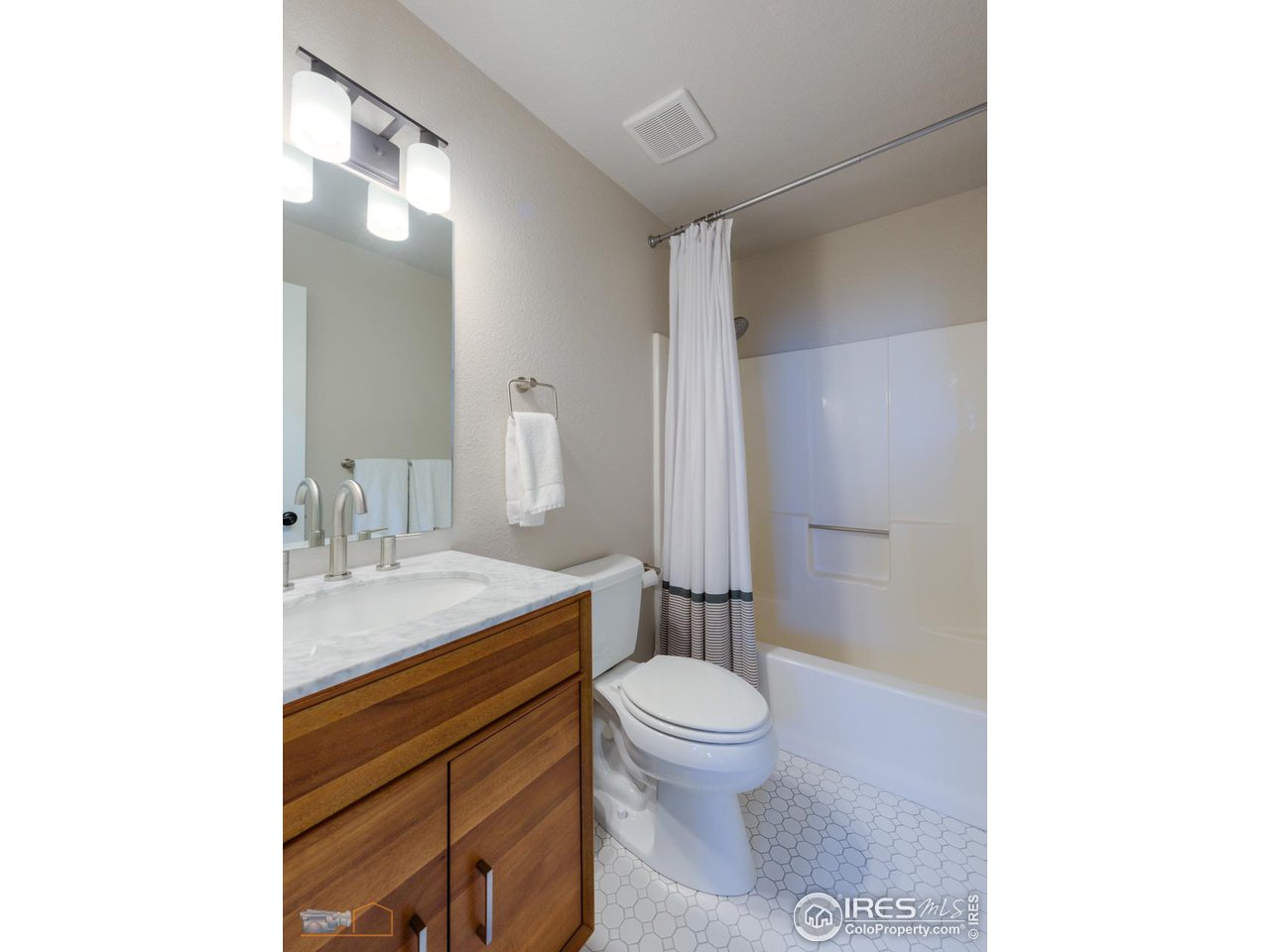 8323 West Fork Road Boulder, CO 80302 - Photo 27 of 36 a bathroom with a granite countertop toilet sink mirror and vanity