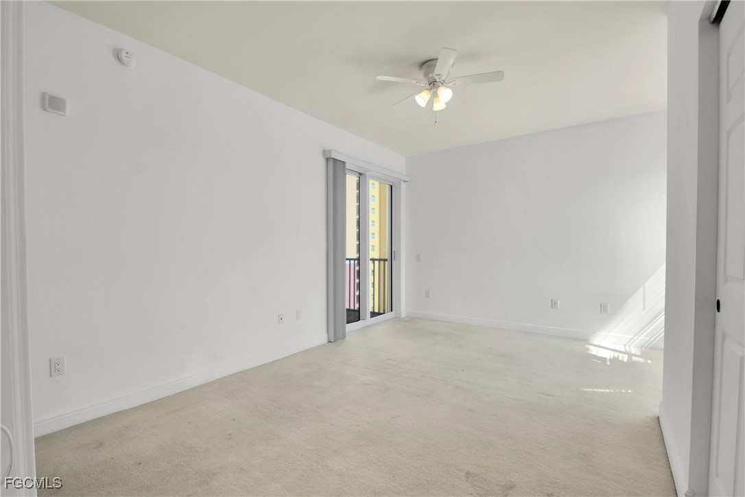 2743 First Street, Unit 1006 Fort Myers, FL 33916 - Photo 19 of 38 an empty room with windows and fan