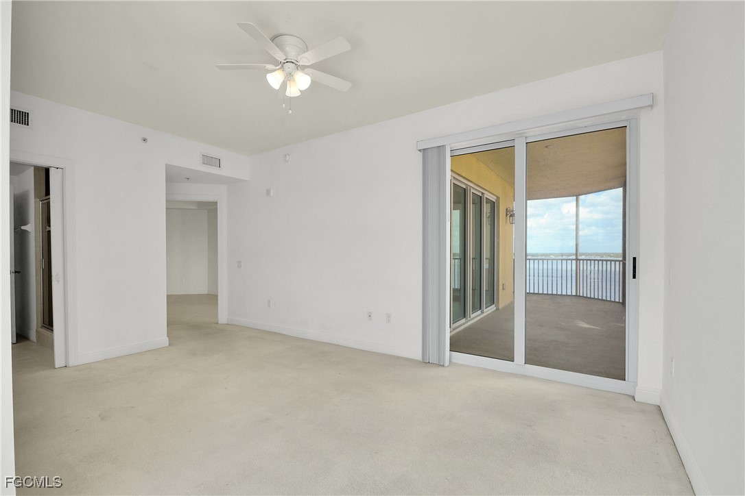 2743 First Street, Unit 1006 Fort Myers, FL 33916 - Photo 20 of 38 an empty room with a ceiling fan and a window