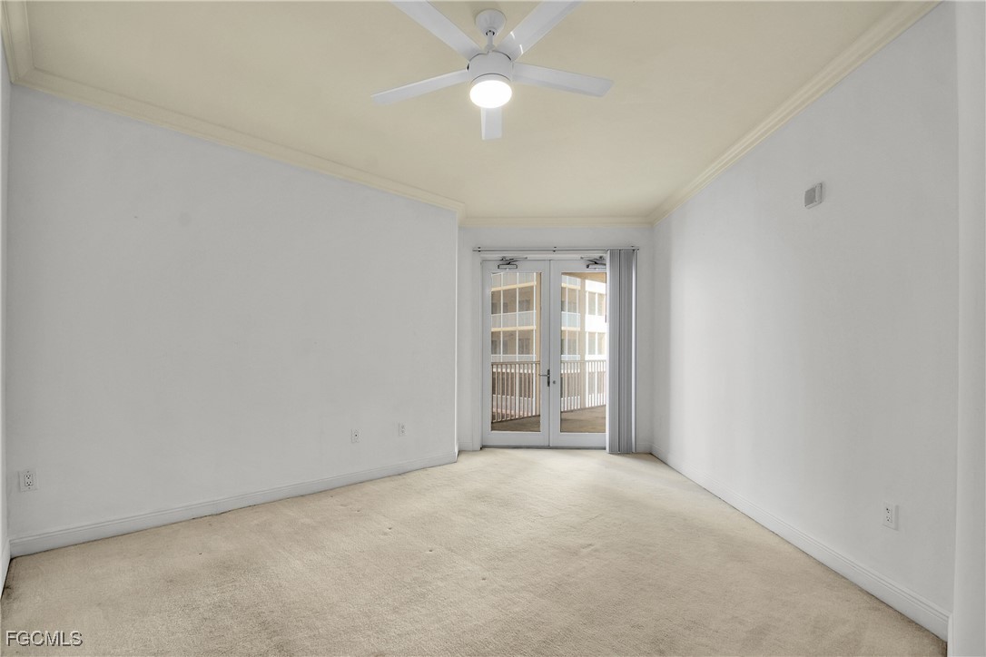 2743 First Street, Unit 1006 Fort Myers, FL 33916 - Photo 27 of 38 an empty room with windows and fan