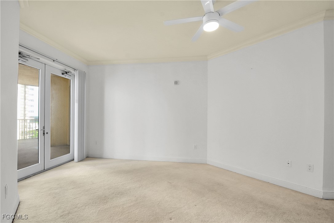 2743 First Street, Unit 1006 Fort Myers, FL 33916 - Photo 29 of 38 an empty room with a ceiling fan and a window