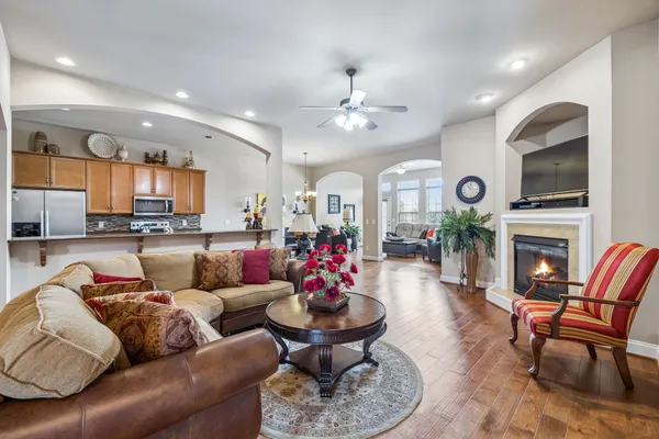 a living room with furniture kitchen and a fireplace