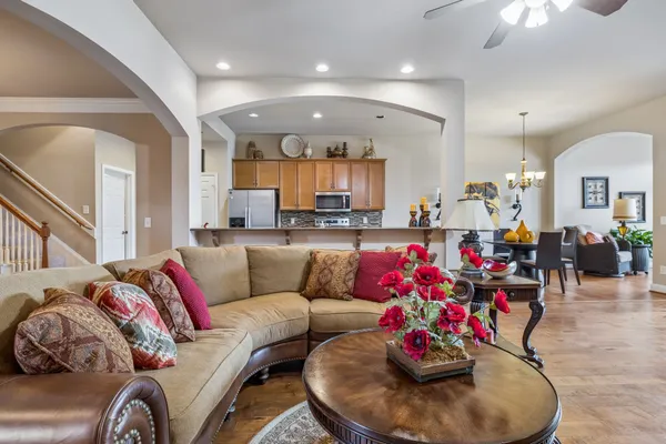 a living room with furniture and kitchen view