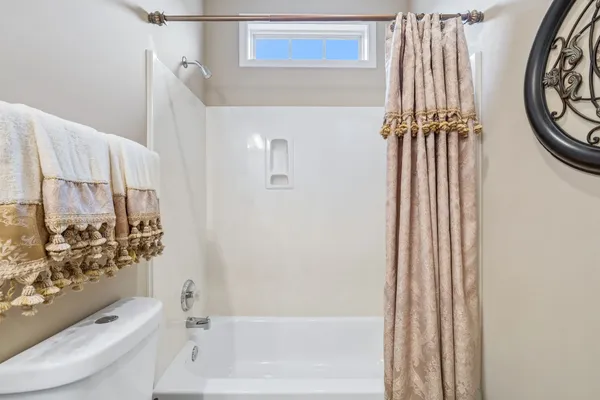 a bathroom with a toilet and a bathtub
